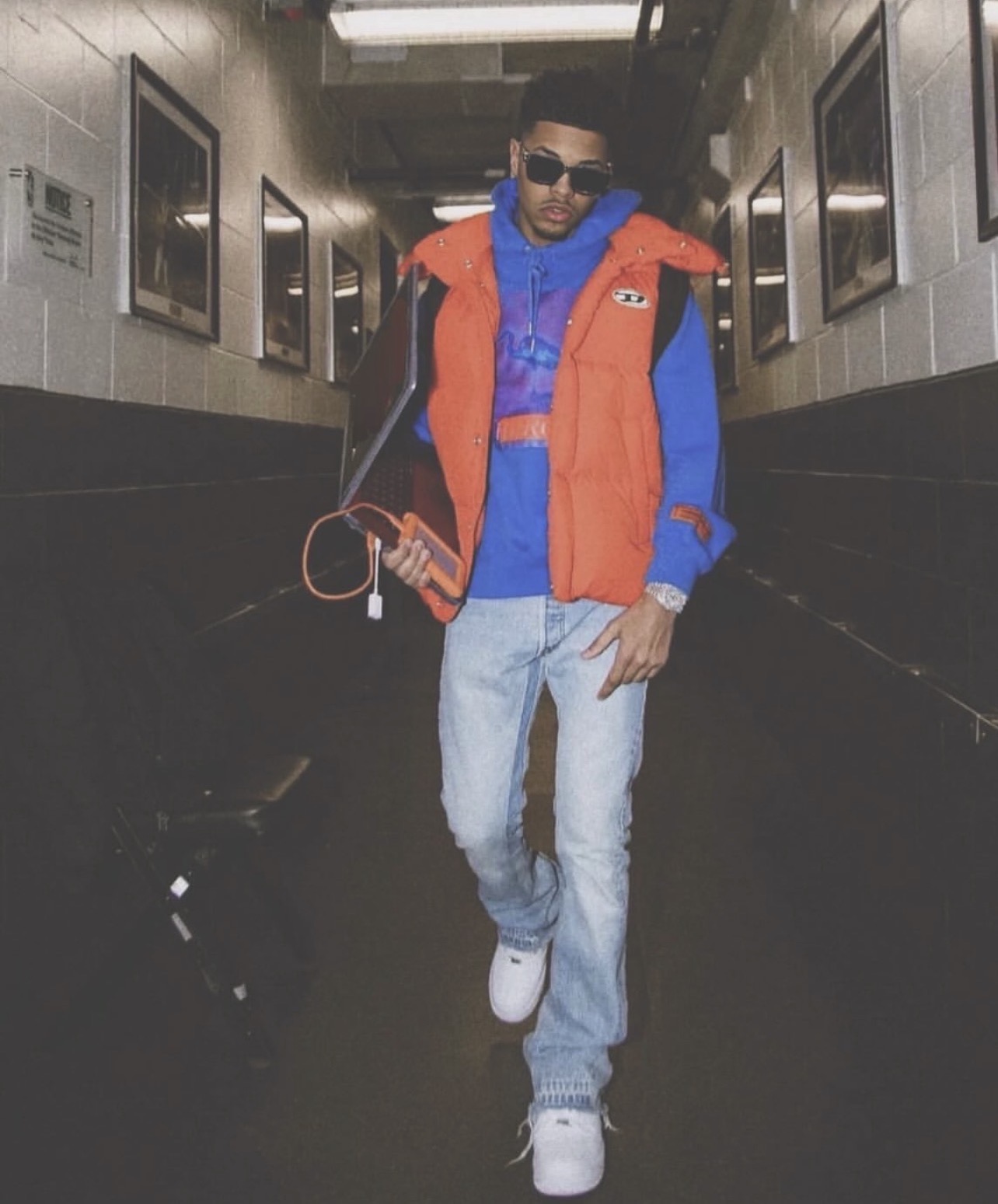 CJ WestCoast walking backstage with his laptop before a show